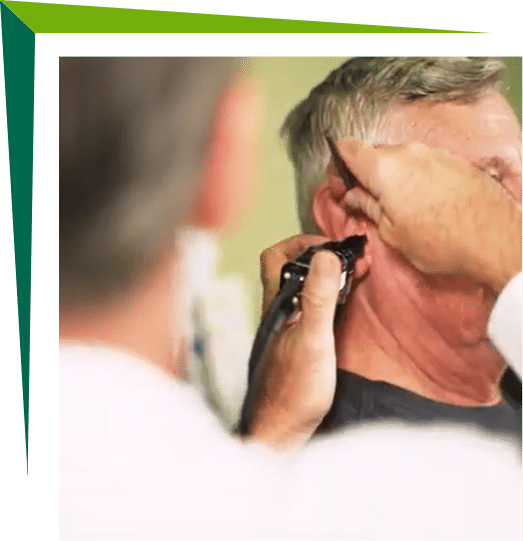 Man getting his ears checked by an audiologist