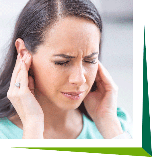 Woman suffering with tinnitus pain